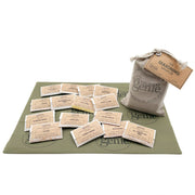 Collection of seasoning packets with a bag labeled 'Culinary Genie' on a green mat.